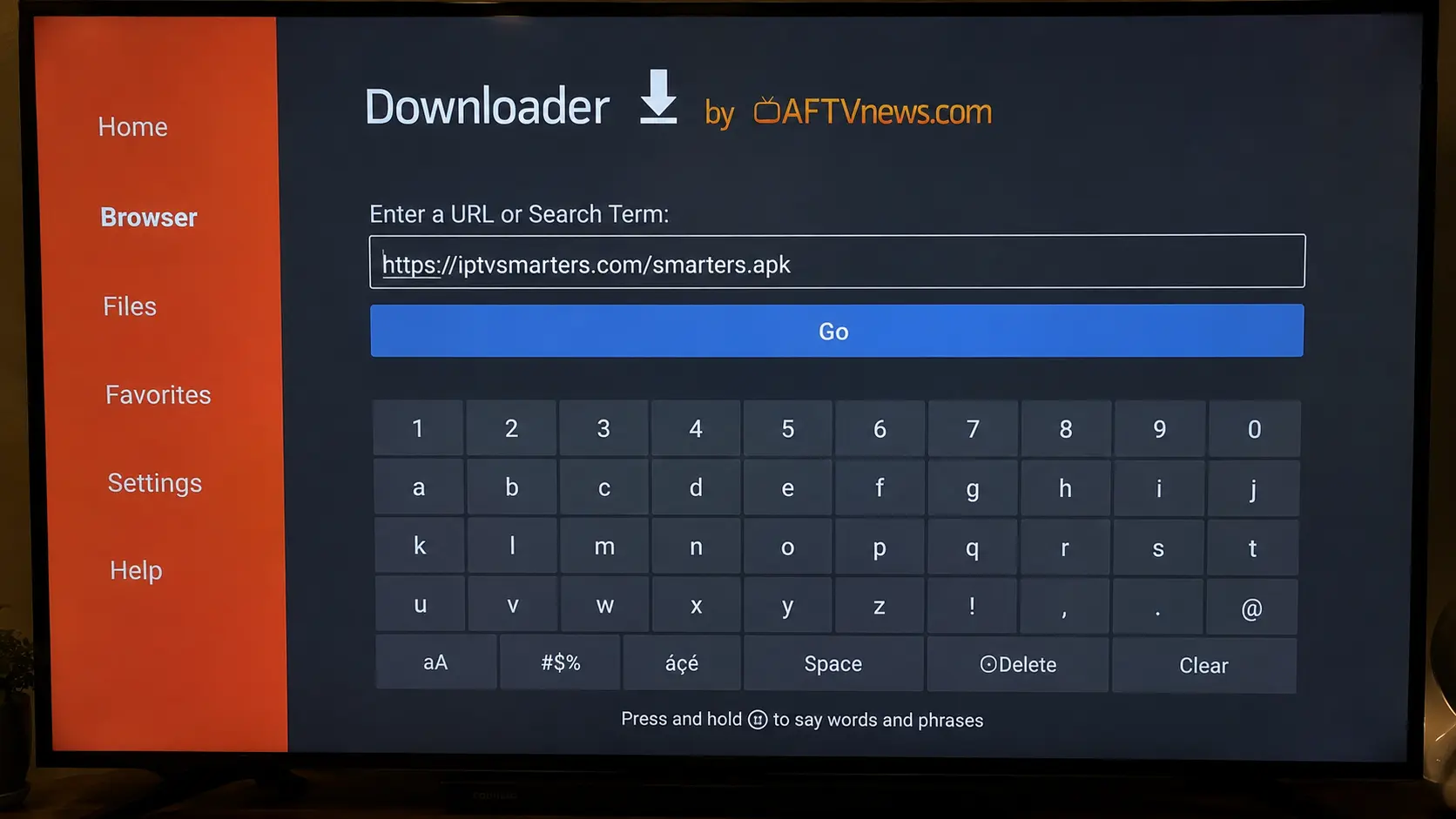 Entering the IPTV Smarters Pro download URL in the Downloader app on Firestick